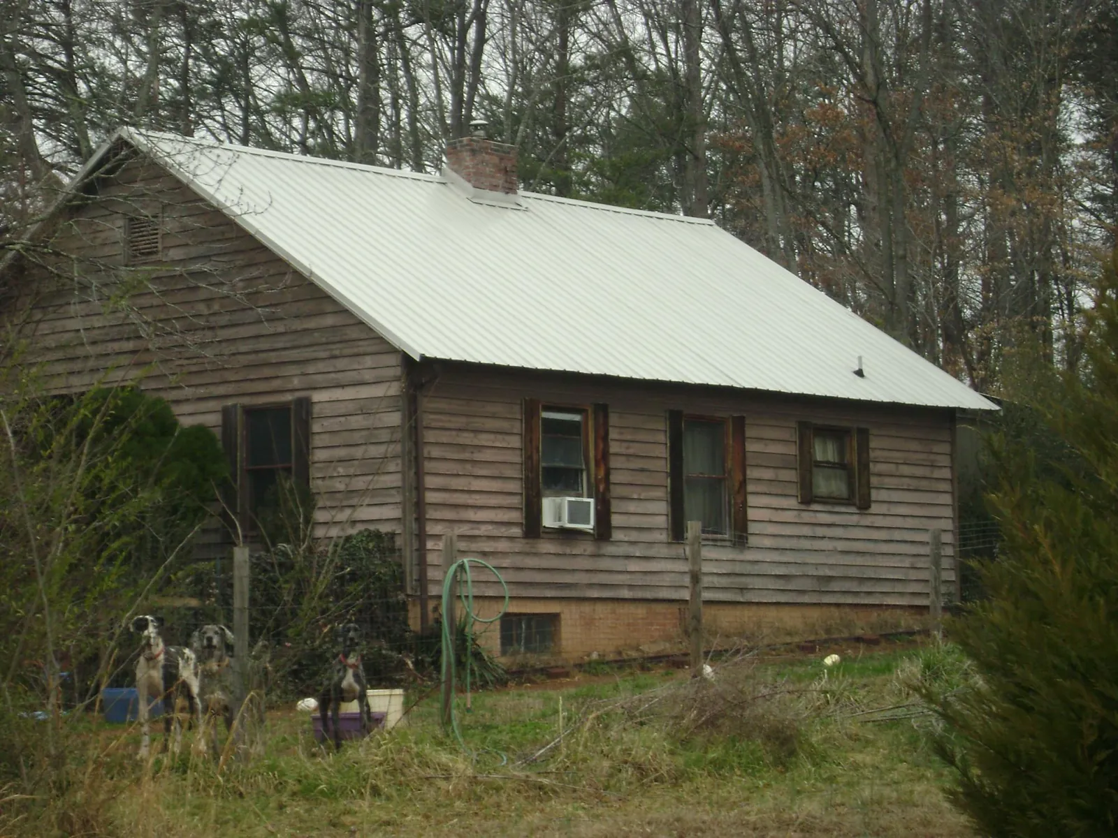 White metal roof on an old wood sided farmhouse, from a Metal Roof Installation job in Southport